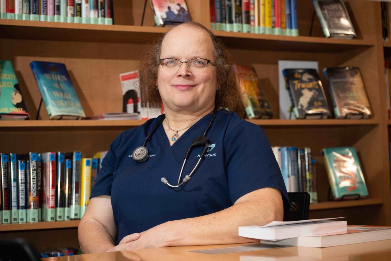 Jennifer Booker sitting at a table in the library