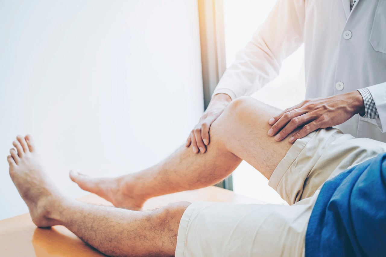 PT working with a patient on his knee