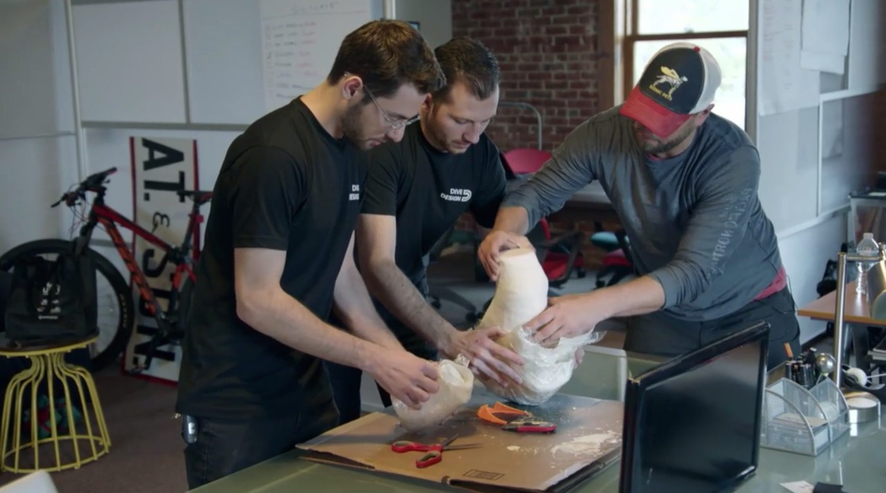 Group of Adam, Alex and Derrick working on a mold.