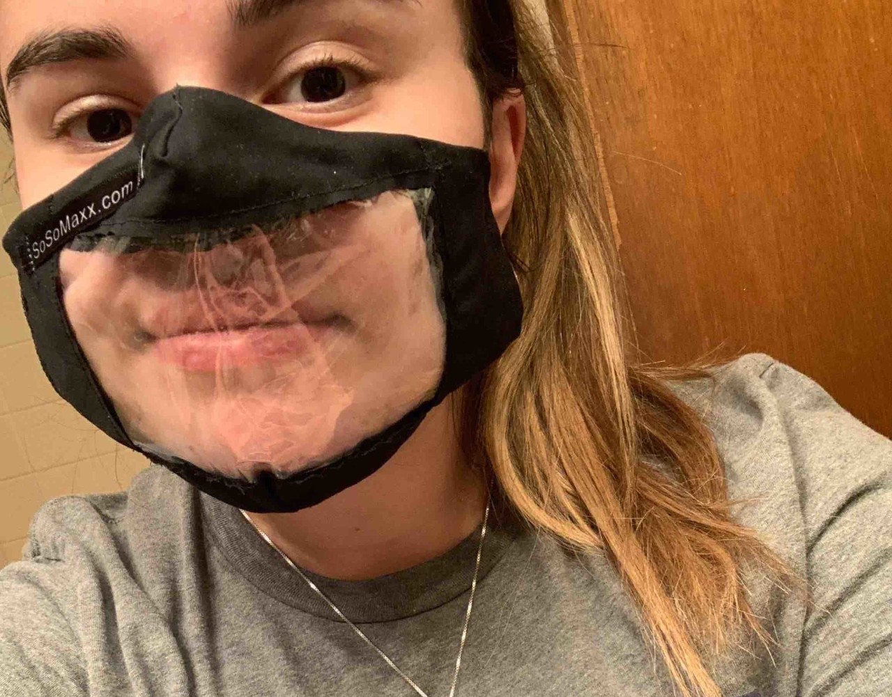 Person wearing a clear mask.