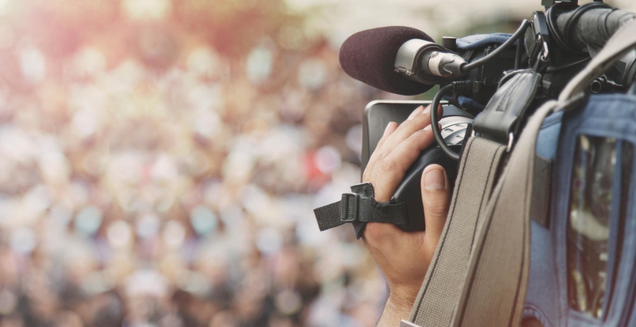 Cameraman shooting crowd