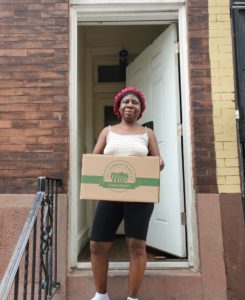 A residents receives a box of food