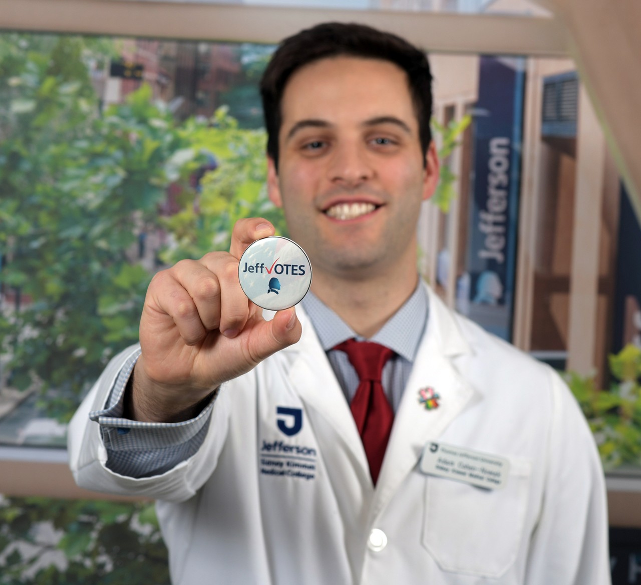 Adam Cohen-Nowak holds up a voting button