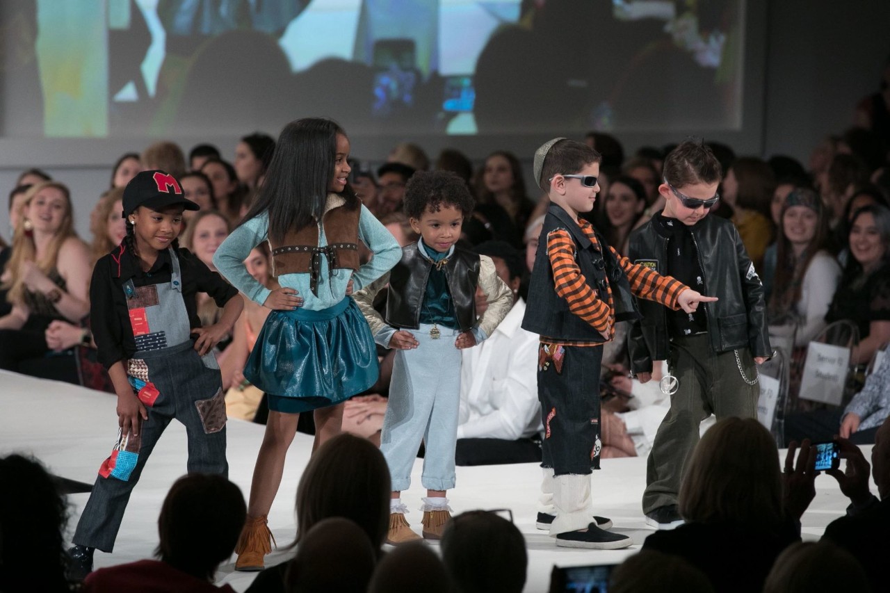 Children walking down a fashion runway
