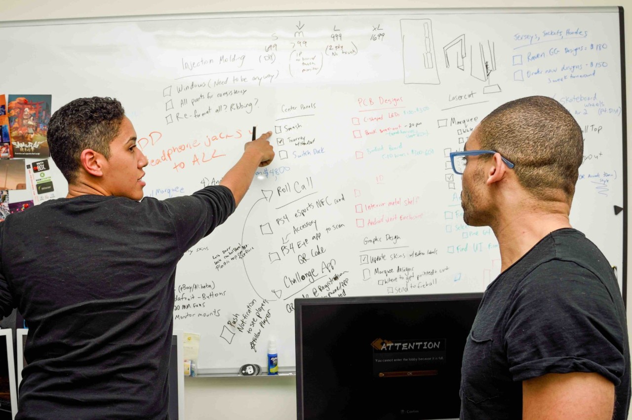 Kyra working at a whiteboard