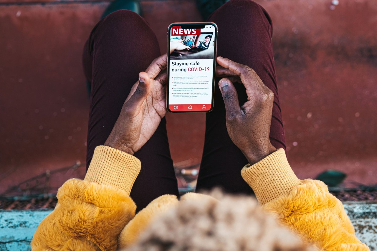 Black woman reading news about COVID-19