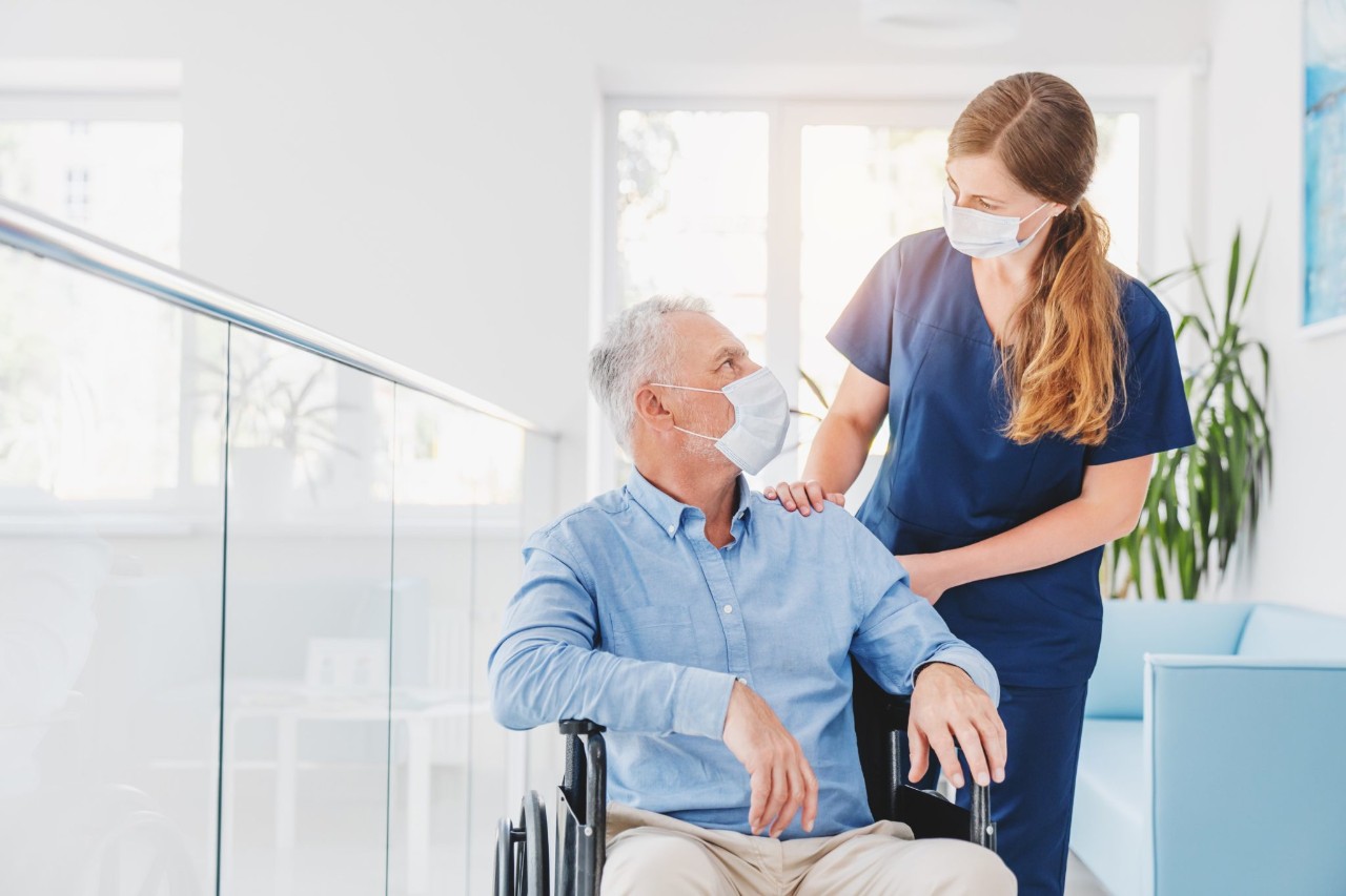 Healthcare provider working with a patient in a wheelchair