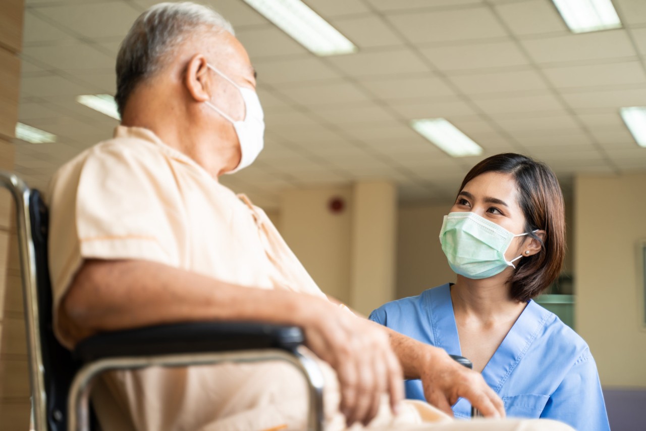 Healthcare provider caring for a patient in a wheelchair