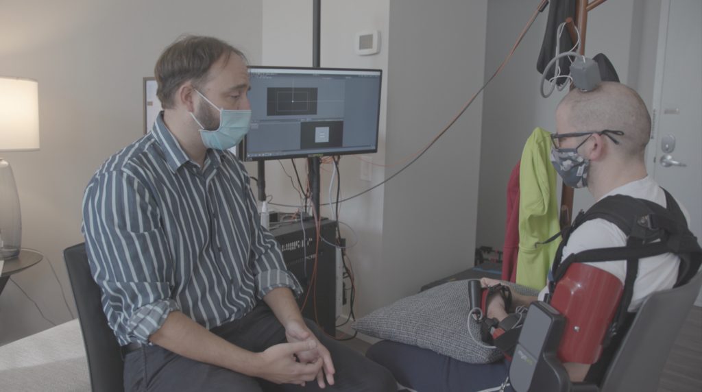Dr. Serruya working with Aaron to control the arm brace