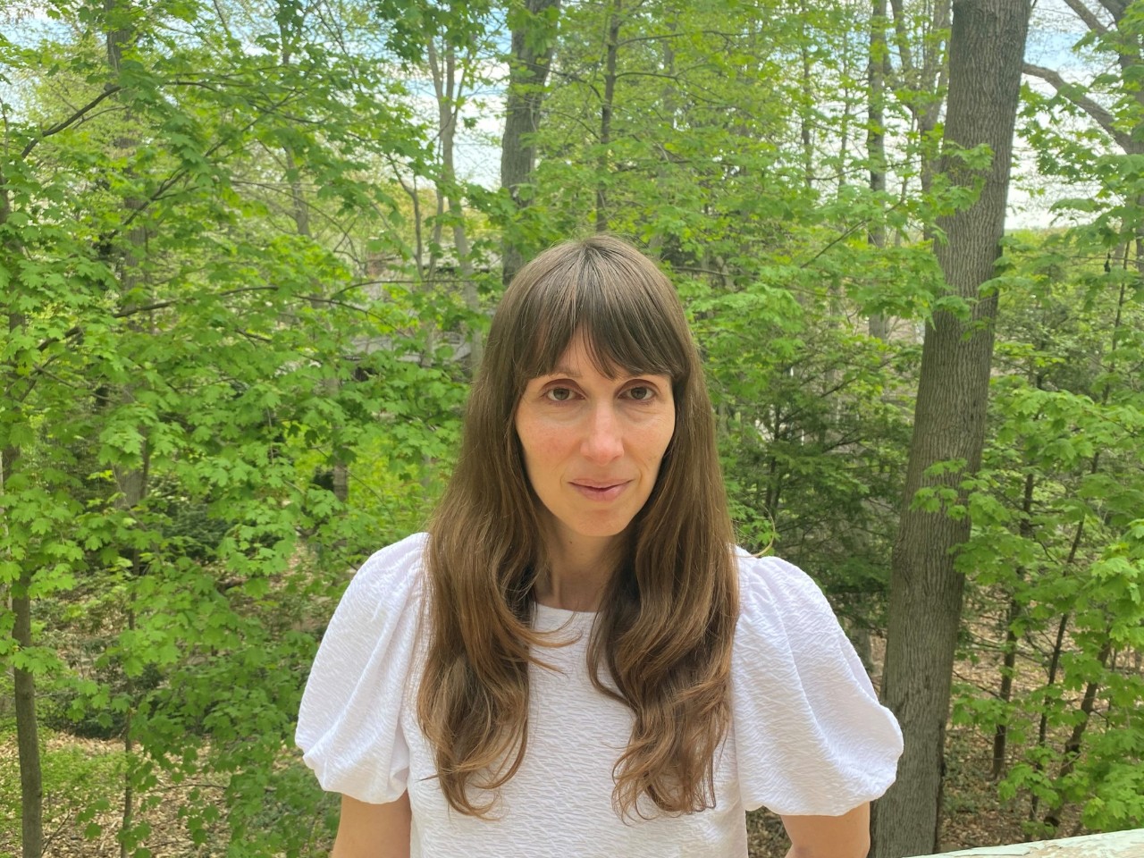 woman standing in front of trees
