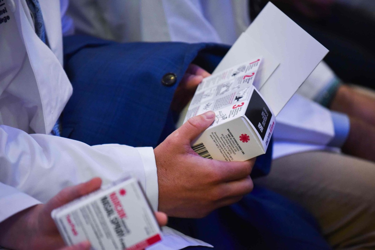 Student holding Narcan kit