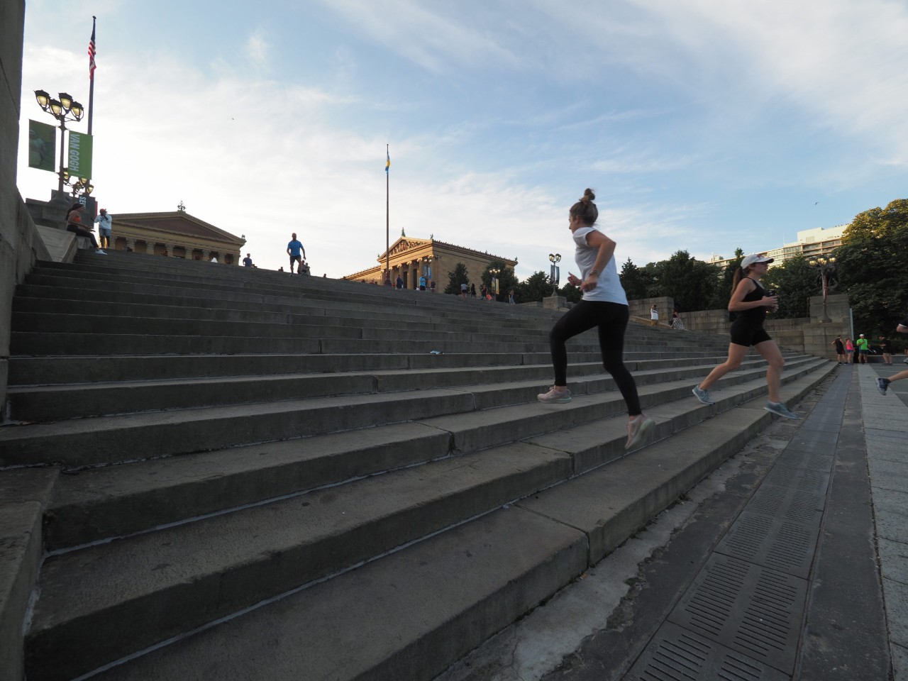 People running up Art Museum steps
