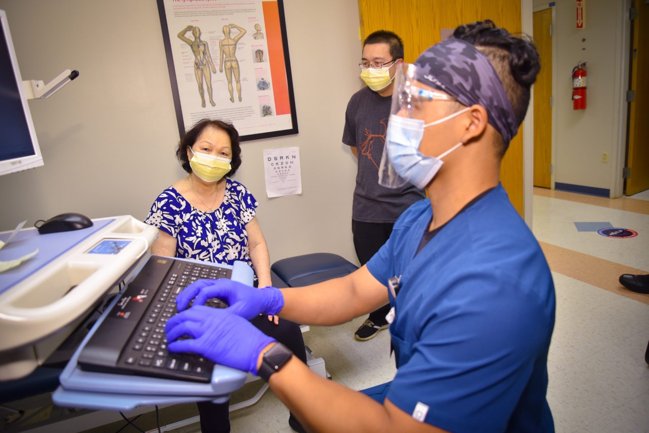 PT student Putira Peter Siv working with a patient.
