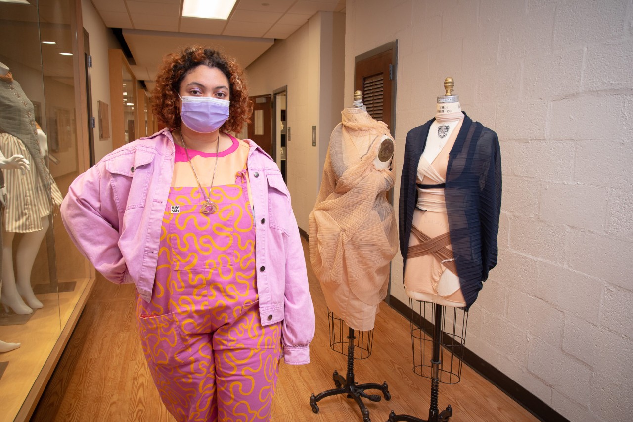 Mahdiya Trudeau-Williams standing next to her designs