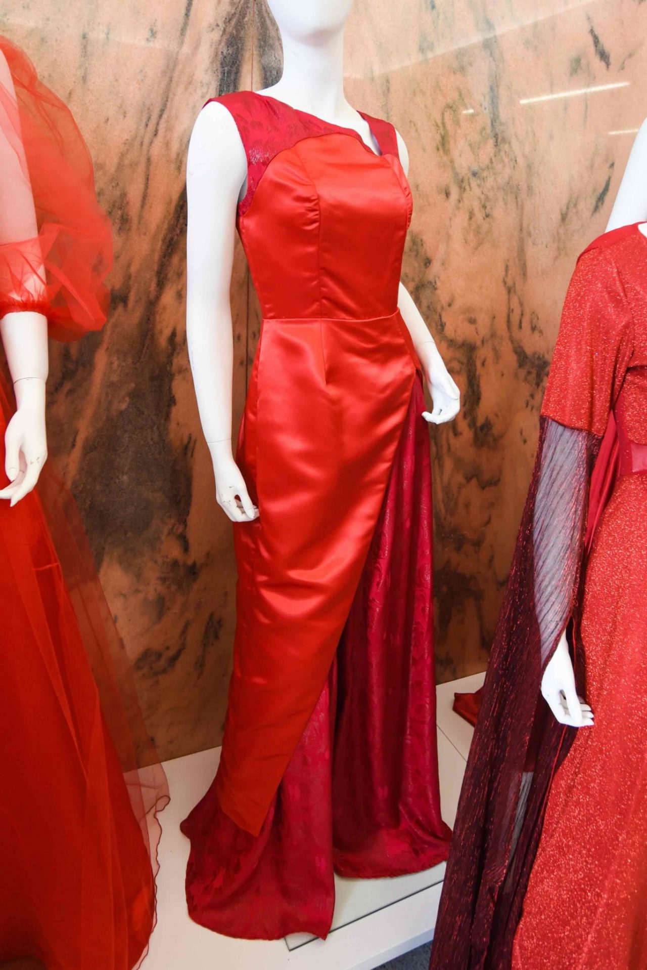Rwan Osman, “Walk Femininely” This spring/summer eveningwear look is inspired by Eastern Asian flowers and Chinese culture. Red in Chinese culture is a powerful symbol of luck, joy and happiness. The print featured illustrates nature through a floral print and revivification with metallic thread. The solid red satin represents femininity and power. The target customer is a young adult, ages 25-32, who wants to showcase the floral design and Eastern Asian influences in a modernized way but is still brave enough for the asymmetry of this dress.