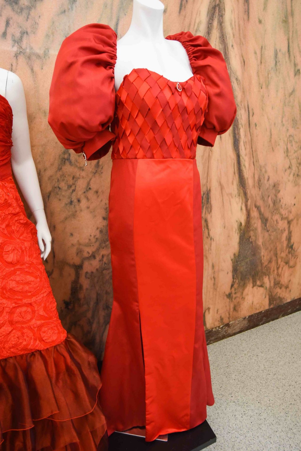 Dwayne Smith, “Blood Diamonds” This dress is inspired by the mining of diamonds, sometimes called “blood diamonds,” from Sierra Leone and other African nations. Diamond mines have been located throughout Africa since the 1860s, and by 1990, African mining was responsible for about 90% of the world’s production of rough diamonds. As a result, demand for these valuable diamonds skyrocketed throughout the world. A variety of art and craft styles prevalent in Sierra Leone also inspired this dress. Wood, ivory and stone carving have been prominent for centuries in this country. Inspiration is derived from the weaving techniques found in traditional baskets, and this is translated into the final design.