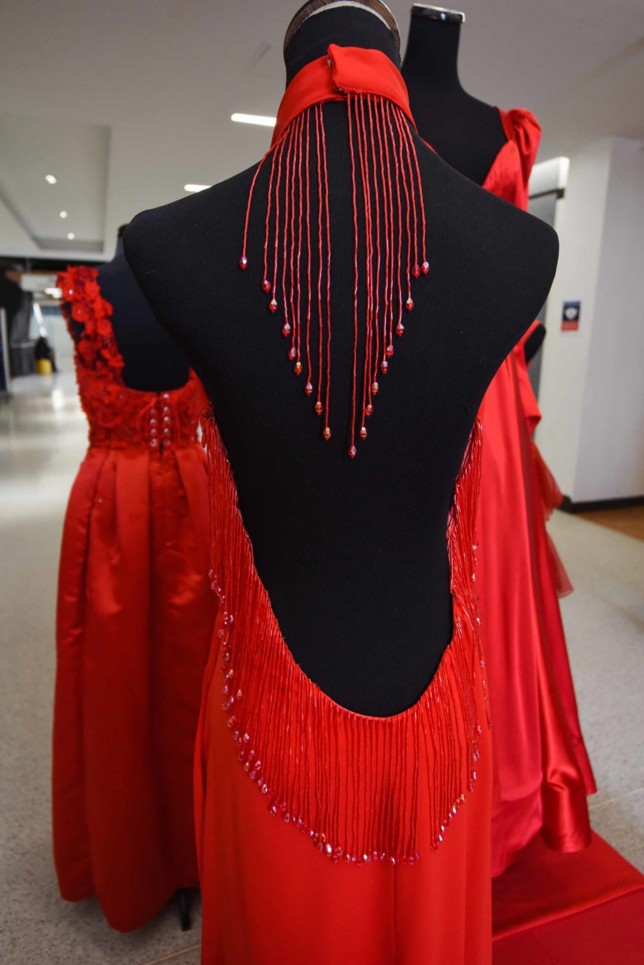 Emily Fitzgerald, “Heart Beats Like a Drum” After researching heart disease in women, I was intrigued by how the heart beats, which connected me to my main inspiration: drums. My dress silhouette is inspired by the shape of the goblet drum. The glass beads and fringe featured in my dress mimic similar elements, which enhance the drum’s design. The beaded fringe was also added to create movement and sound when the garment is in motion. I created this dress in honor of Christina LoPresti, who passed away in 2006 after her battle with heart disease. The dress makes a statement, encouraging the women who wear it to beat, with their hearts, to their own drum.