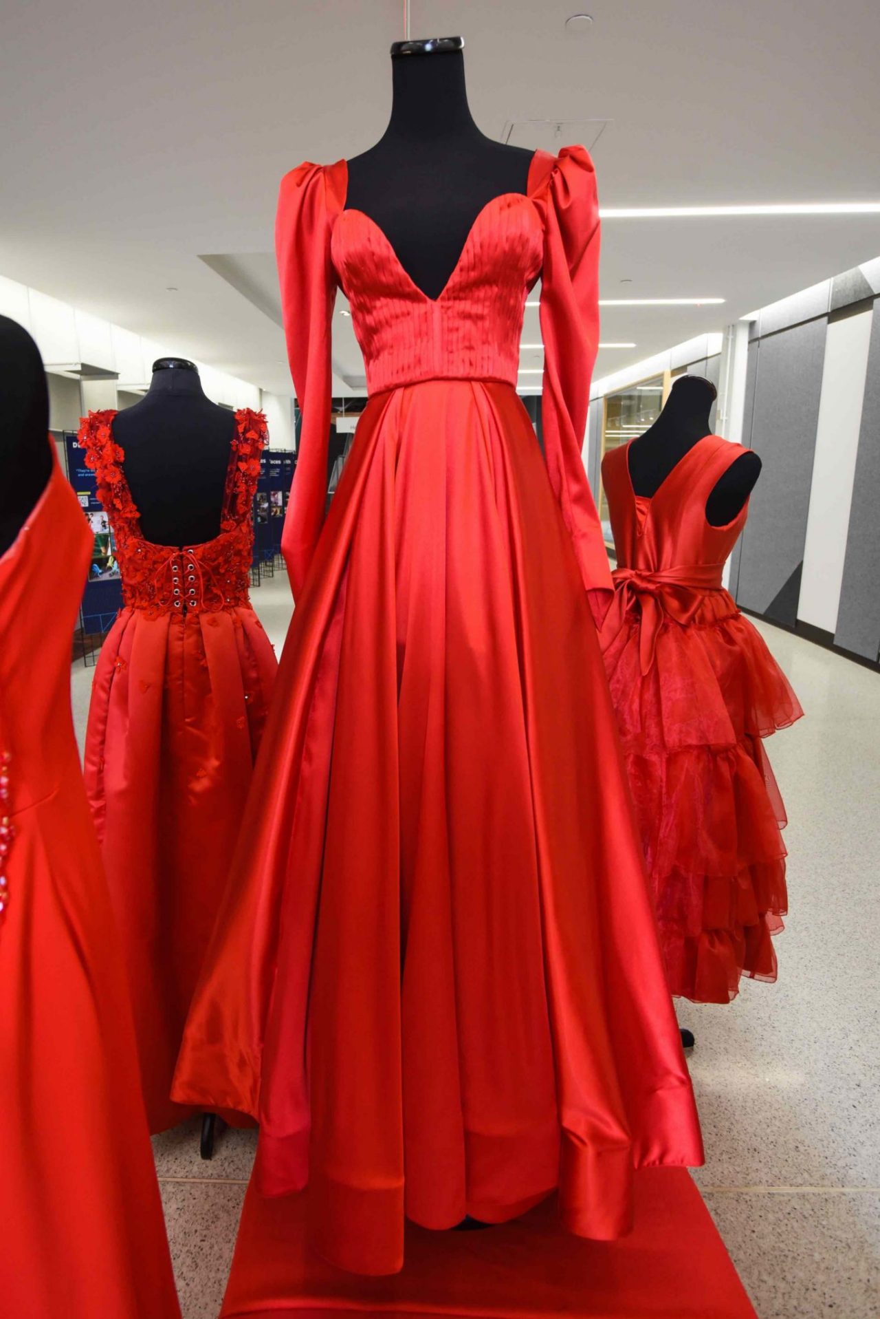 Lauren Schuler, “Powerful Queen Elizabeth” This red dress, designed for the fall/winter season, is a symbol of powerful and strong women. Queen Elizabeth I and Elizabethan fashion are the inspiration for this dress. A special focus was placed on ways the Queen specifically dressed to look more powerful than the men around her. A simple but rich satin is used as the primary fabric to allow for the focus of the dress to be on the seamlines and to create unique texture through pleating. Women should support one another when it comes to topics such as heart disease, and one of the biggest ways to support is to spread awareness.