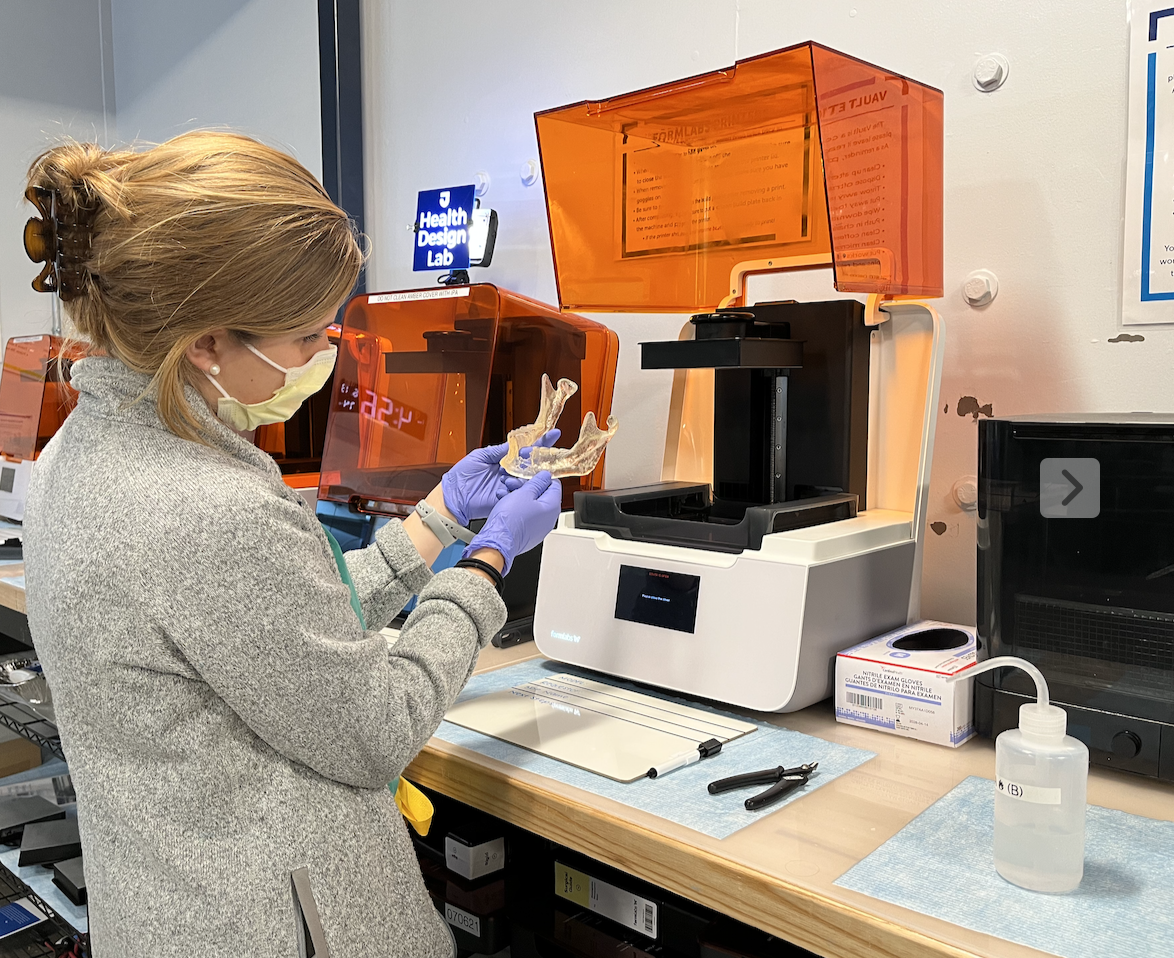 Lauren evaluating a mandible model after it’s been printed and processed