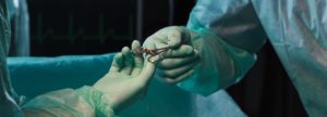 Surgeons' hands holding pliers