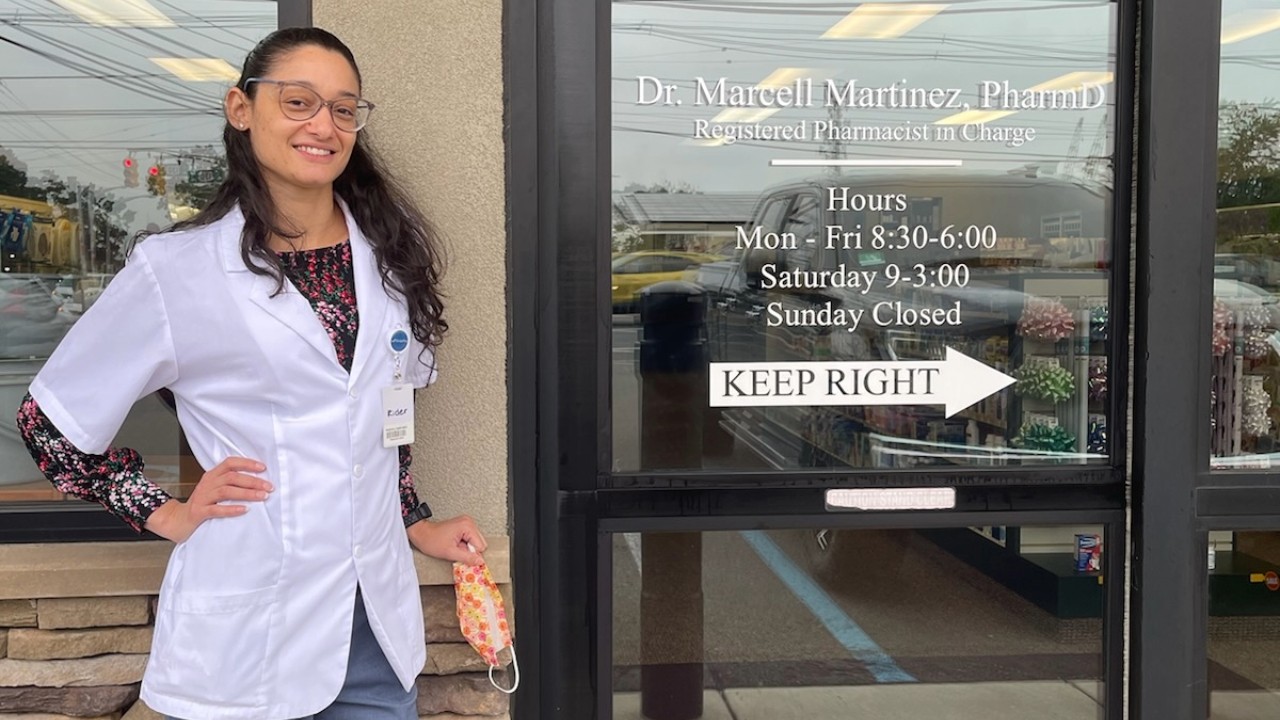 Dr. Marteniz in front of her pharmacy