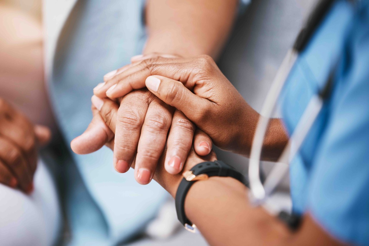 Doctor holding a patient's hand