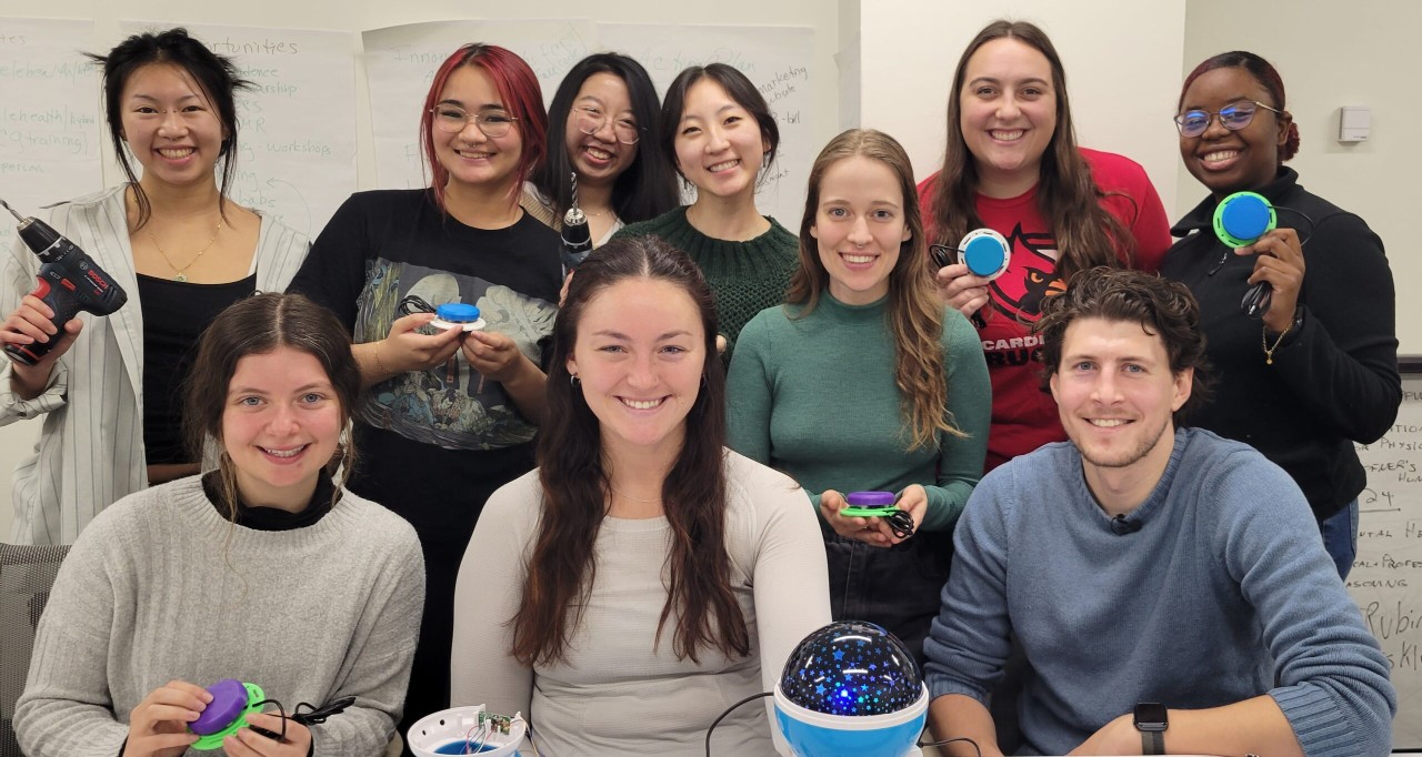 Adjunct faculty member Zach Samalonis (bottom right) and students in his 3D Printing and Rehabilitation class show off the accessible, 3D printed buttons they created and a finished, adaptive star dome toy. The toys and their new buttons will be distributed to children with disabilities.