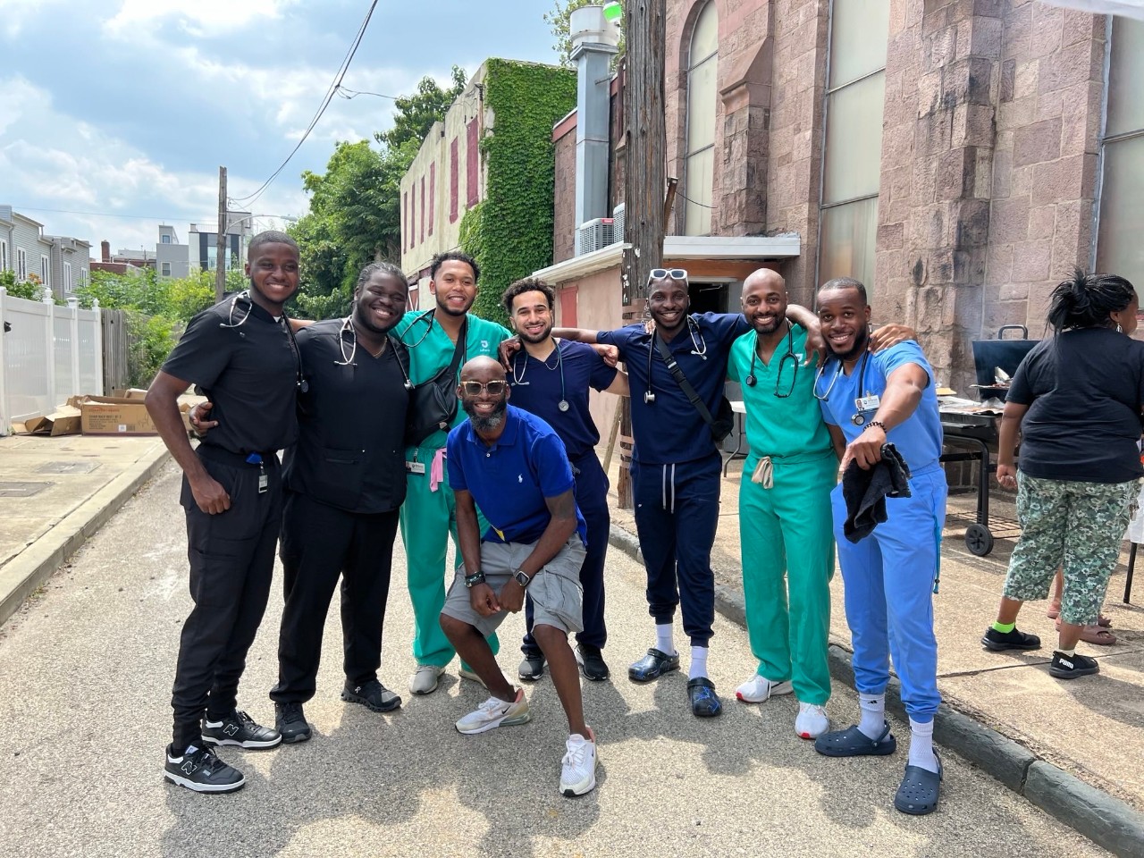 Group photo of black men in white coats