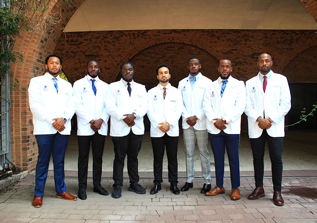 Group photo of Black Men in White Coats