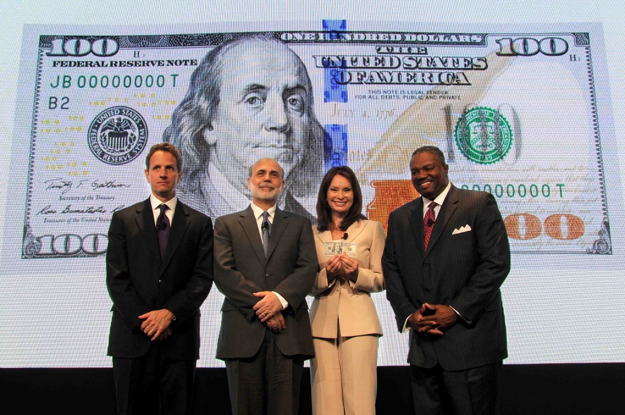(Left to Right) Secretary Timothy Geithner, Federal Reserve Board Chairman Ben Bernanke, Treasurer of the United States Rosie Rios and Deputy Director of the Secret Service Keith Prewitt unveil the newly designed $100 note at the U.S. Treasury Department in Washington, DC, Wed., April 21, 2010. (Photo by Robin Weiner)