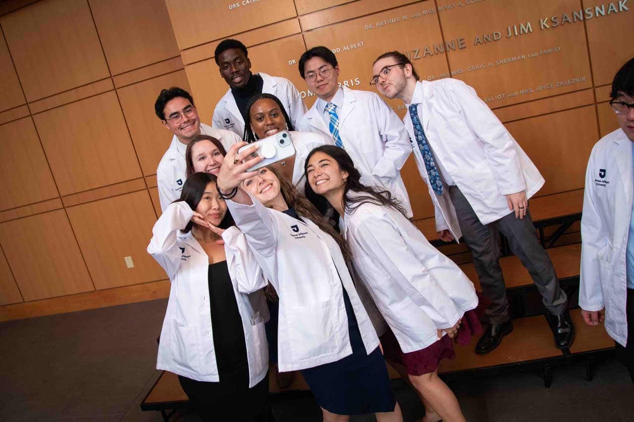 The Pharmacy Class of 2028 celebrates after receiving their white coats.