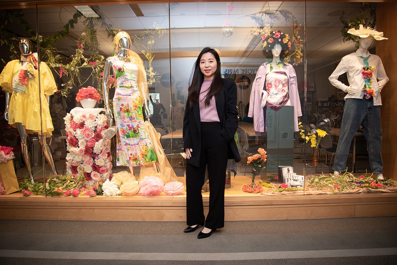 asian woman standing in front of cabinet