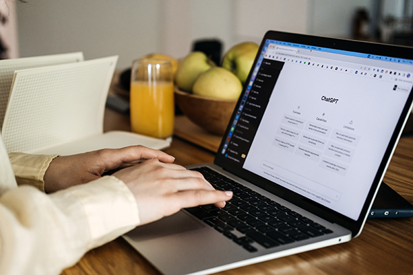 ChatGPT for content creators, ChatGPT help generate ideas and create content. Screen with ChatGPT AI or artificial intelligence chat and typing female hands. Warsaw, Poland - May 02, 2023.