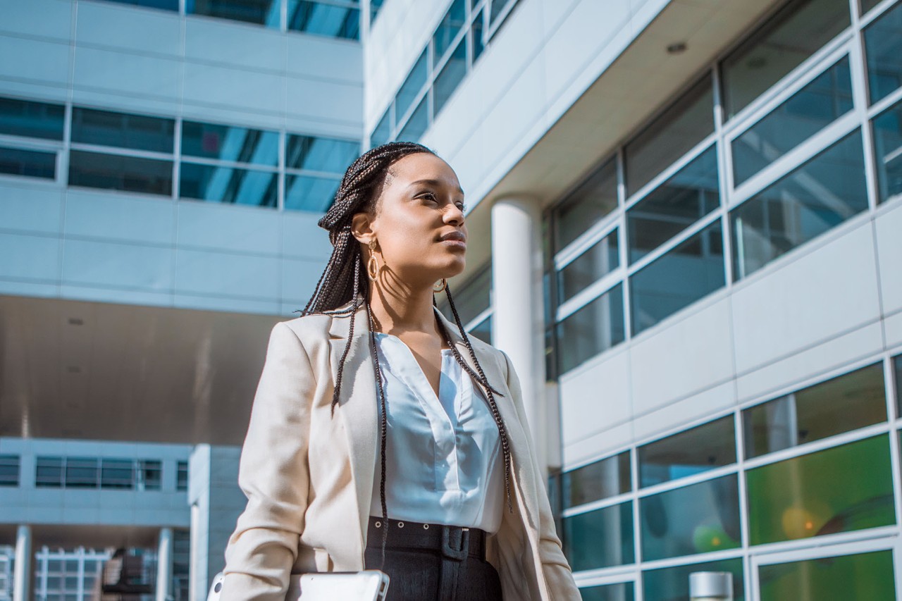 Female professional business woman outdoors on an office complex in the Spring daytime