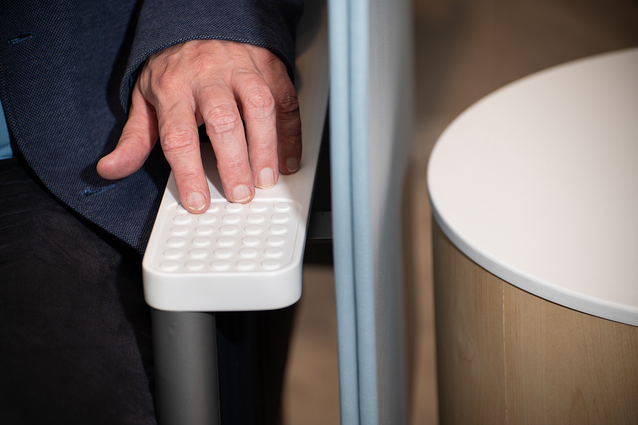 Rob Melville showcases the textured armrest which is part of the sensory seating. Photo Credit: ©Thomas Jefferson University Photography Services.