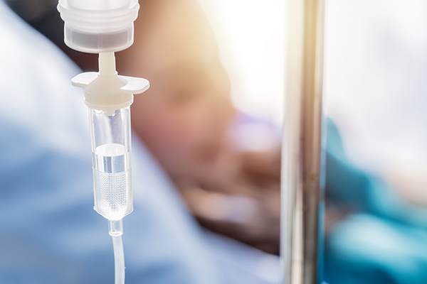 Closeup of the IV drip on the hanger. Selective focus.